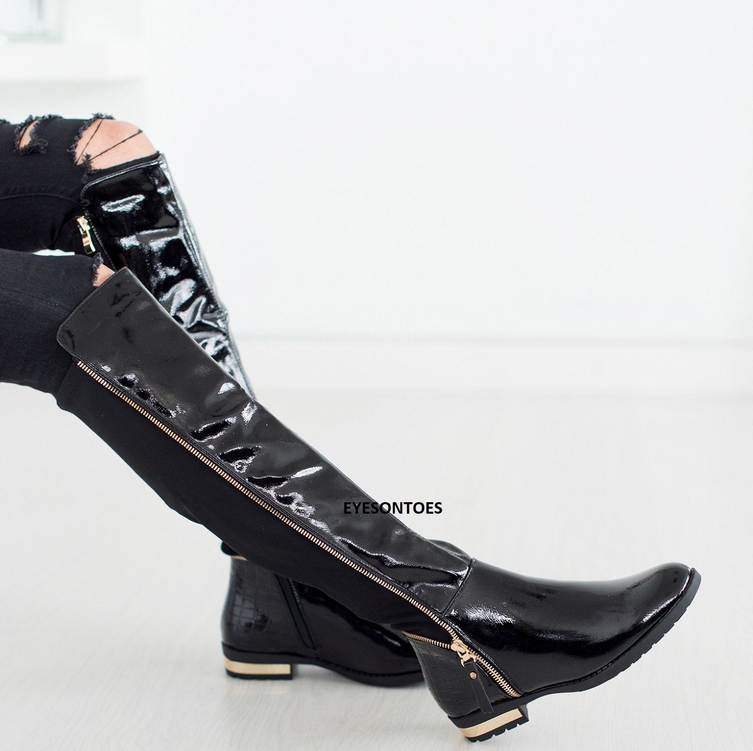 black over the knee boots with gold zipper